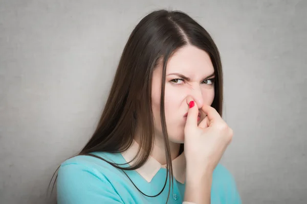 Woman closes her nose — Stock Photo, Image