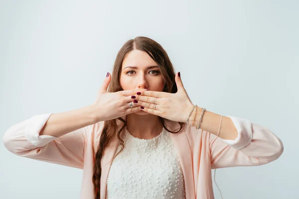 Girl covers her mouth with hands — Stock Photo, Image