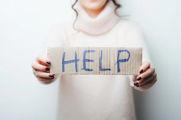 Woman holding help text — Stock Photo, Image