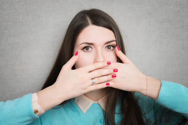 Girl covers mouth with hands — Stock Photo, Image