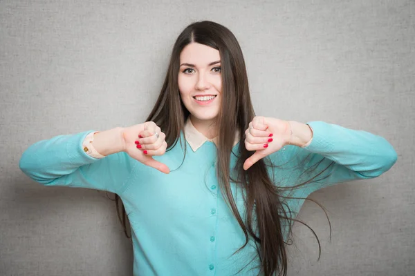 Woman shows thumbs down — Stock Photo, Image
