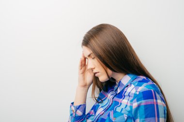 Baş ağrısı olan genç bir kadın.