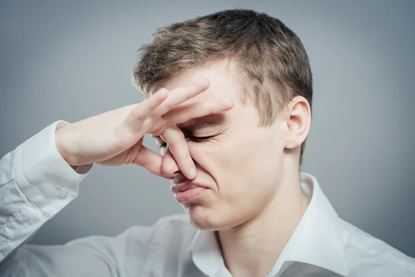 Man closing nose — Stock Photo, Image