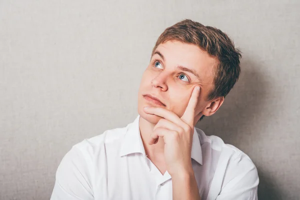 Young man thinks — Stock Photo, Image