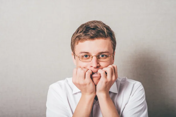 Man bites his nails — Stock Photo, Image