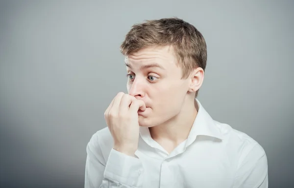 Man biting his finger nails — Stock Photo, Image