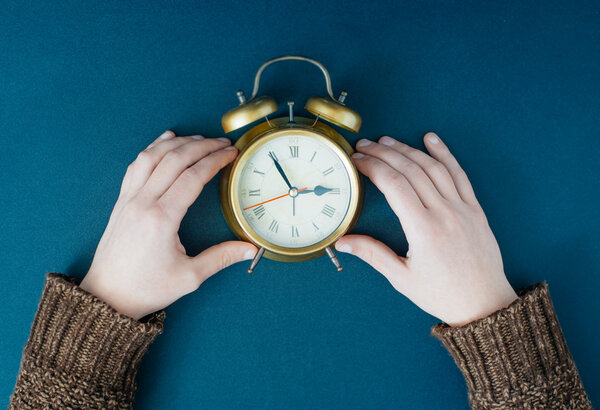 Alarm clock in  hands