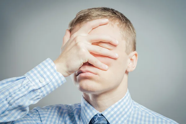 Man closes his eyes with his hand — Stock Photo, Image