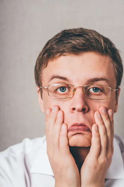 Man holding hands on his cheeks — Stock Photo, Image