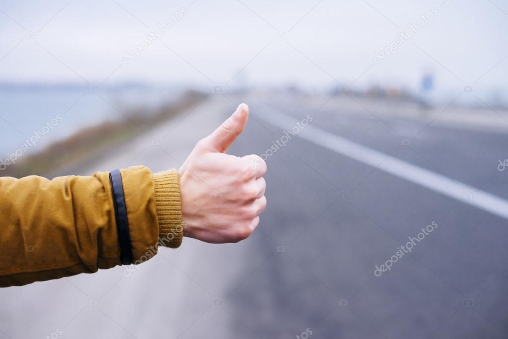 Hitchhikers sign thumb up