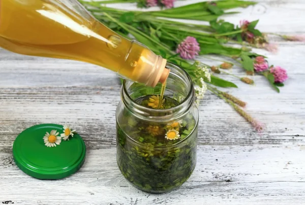 Herbal organic oil made from herbs and olive oil — Stock Photo, Image