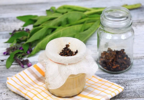 Alternative medicine,  filtering Comfrey ointment good for bones — Stock Photo, Image