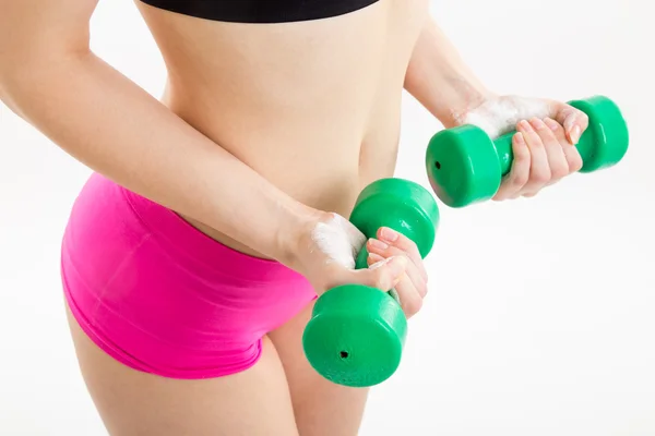 Fitness girl with green dumbbells — Stock Photo, Image