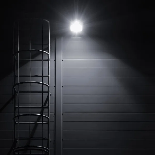 Fire emergency rescue access escape ladder stairway roof maintenance stairs night bright shining lantern lamp light illumination glow shadows, rustic textured industrial building wall panels texture pattern large detailed vertical closeup copy space — Stock Photo, Image