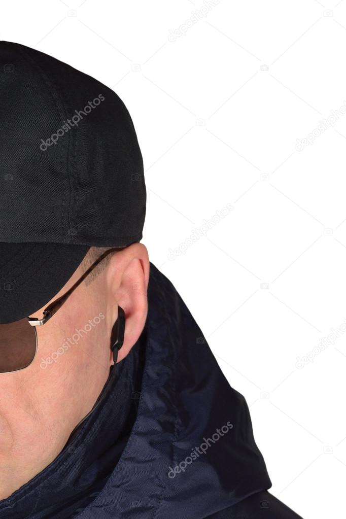 Police security guard staff policeman covertly listening on specop field situation isolated undercover agent covert operations surveillance earpiece closeup, caucasian european ethnicity, large detailed vertical studio shot black specops cop officer