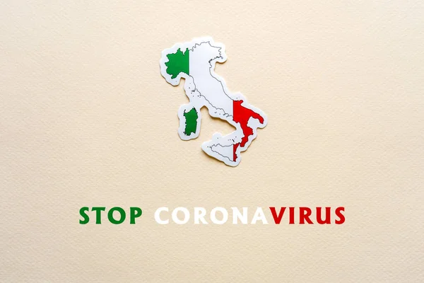 Stop coronavirus in Italy. Map of Italy with italian flag on light paper background. Text STOP CORONAVIRUS. Covid-19 outbreak, pandemic concept.
