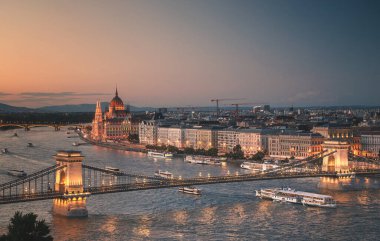 Budapest, Hungary  August 20, 2025: Evening view of the Hungarian Parliament Building and Chain Bridge over the Danube River illuminated at dusk.