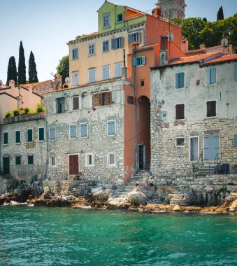 Rovinj, Croatia  June 5, 2024: Colorful historic waterfront houses along the Adriatic coast in Rovinjs old town, Istria region, under bright Mediterranean summer light