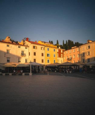Piran, Slovenia  June 18, 2025: Sunset over Tartini Square (Tartinijev Trg) in the old town of Piran, showing historic Mediterranean architecture and warm golden-hour light.
