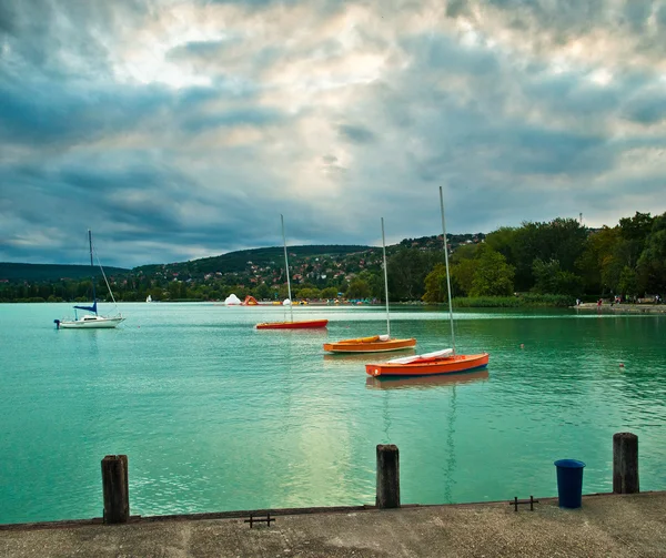 Red sailboats on lake — Stock Photo, Image