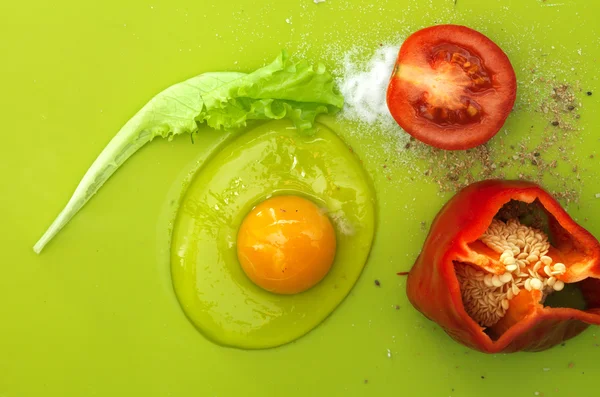 Raw egg yolk on green background — Stock Photo, Image