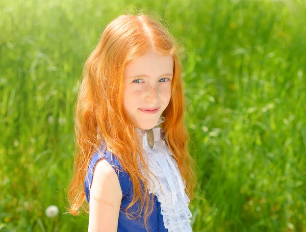 Red-haired girl in a sunny garden — Stock Photo, Image