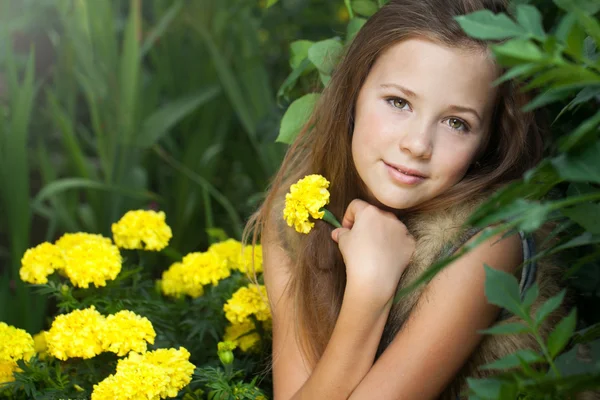 Piękna dziewczyna w pełnym kwiatów ogrodzie — Zdjęcie stockowe
