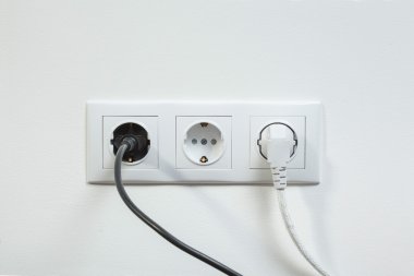 Power plugs plugged in a electric socket clipart