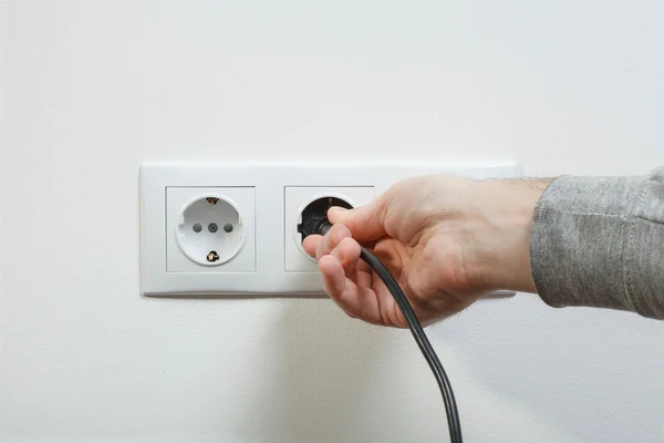 Plugging electrical cable to socket — Stock Photo, Image