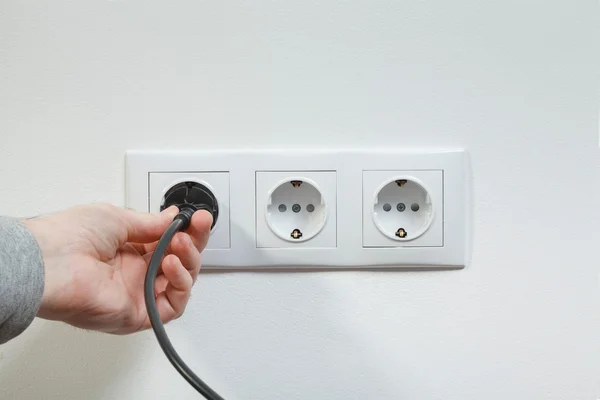 Plugging electrical cable to socket — Stock Photo, Image