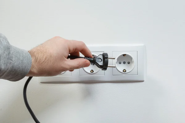 Plugging electrical cable to socket — Stock Photo, Image