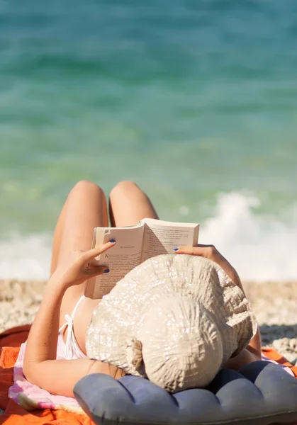 Leisure young girl reading a book at beach Royalty Free Stock Images