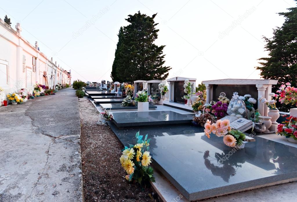 cemetary graves with flowers and tombstone peace place