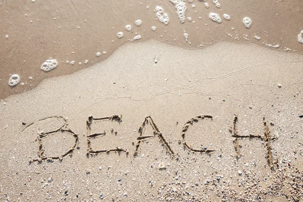 Handwriting word beach at sea beach sand — Stock Photo, Image