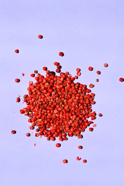 Pile of pink peppercorn on paper background