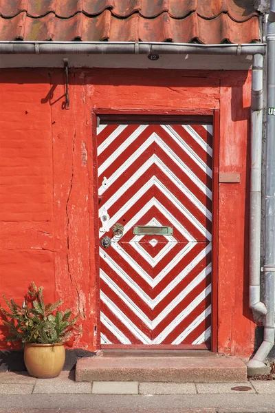 Red house wtih stripy door — Stock Photo, Image