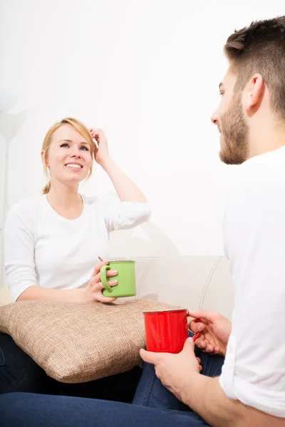 Young couple talking on the Sofa — Stock Photo, Image