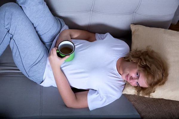 Young woman on the sofa in the early morning — Stock Photo, Image