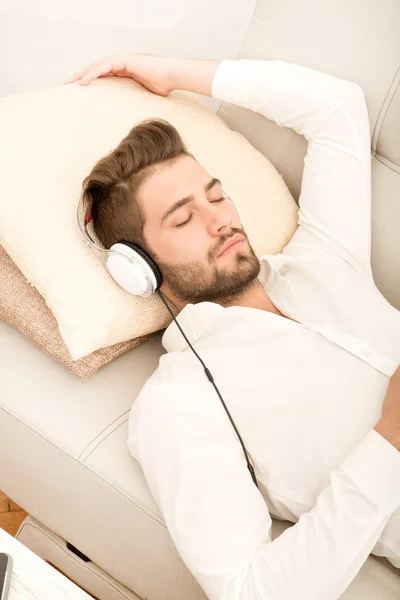 Portrait of young man listening to music — Stock Photo, Image