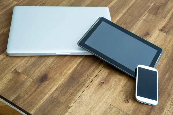 Digital devices on a wooden Desktop — Stock Photo, Image