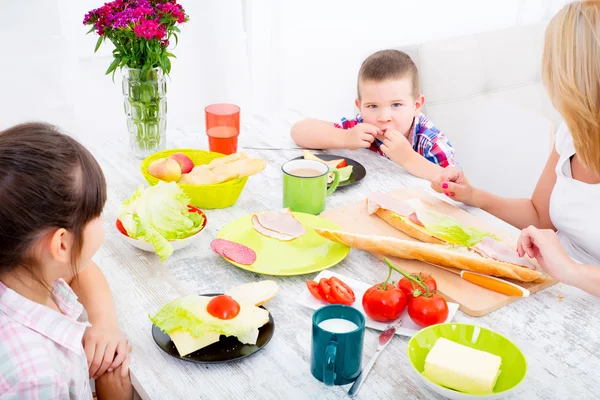 Happy family having breakfast at home — Stock Photo, Image