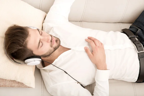 Portrait of young man listening to music — Stock Photo, Image