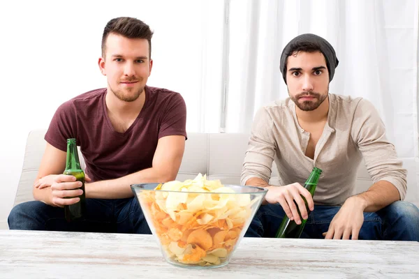 Twee vrienden thuis televisie kijken — Stockfoto