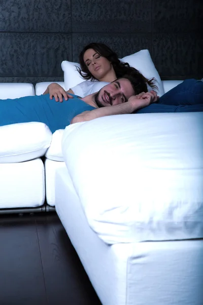 Mladý pár, spí na pohovce v noci — Stock fotografie