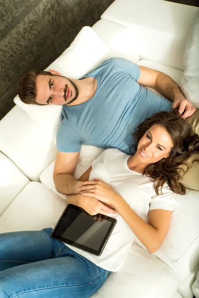 Young couple relaxing on the sofa — Stock Photo, Image