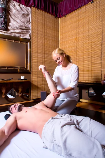 Una joven masajista aplicando tratamiento a un brazo —  Fotos de Stock