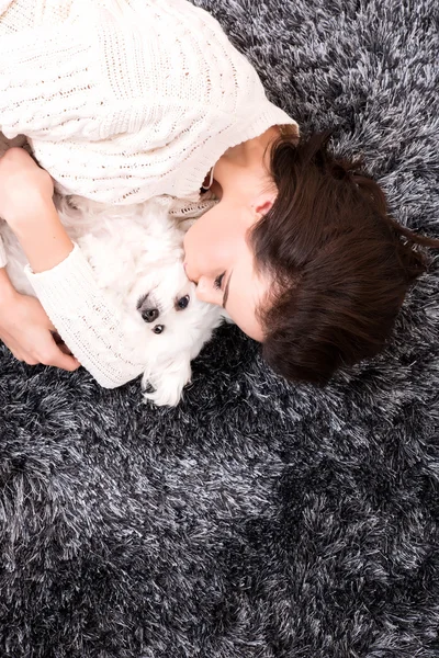 Young beautiful woman hugging her puppy — Stock Photo, Image