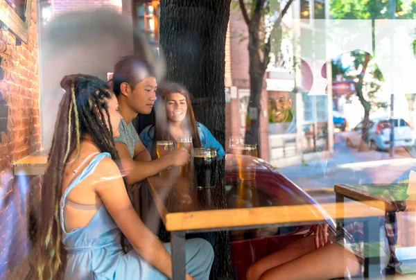 A group of friends together in a bar — Stock Photo, Image