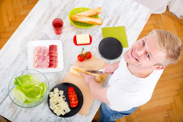 Young man preparing a Sandwich — Stock Photo, Image