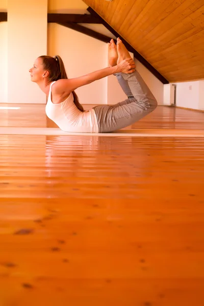 Vrouw die yoga beoefent in een studio — Stockfoto